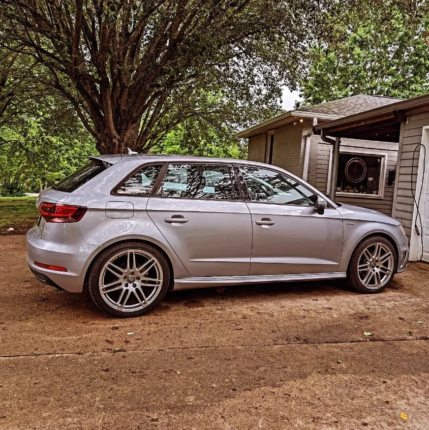 Silver Audi wagon parked outside a garage